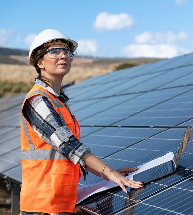 Engineer inspecting solar panels outdoors.